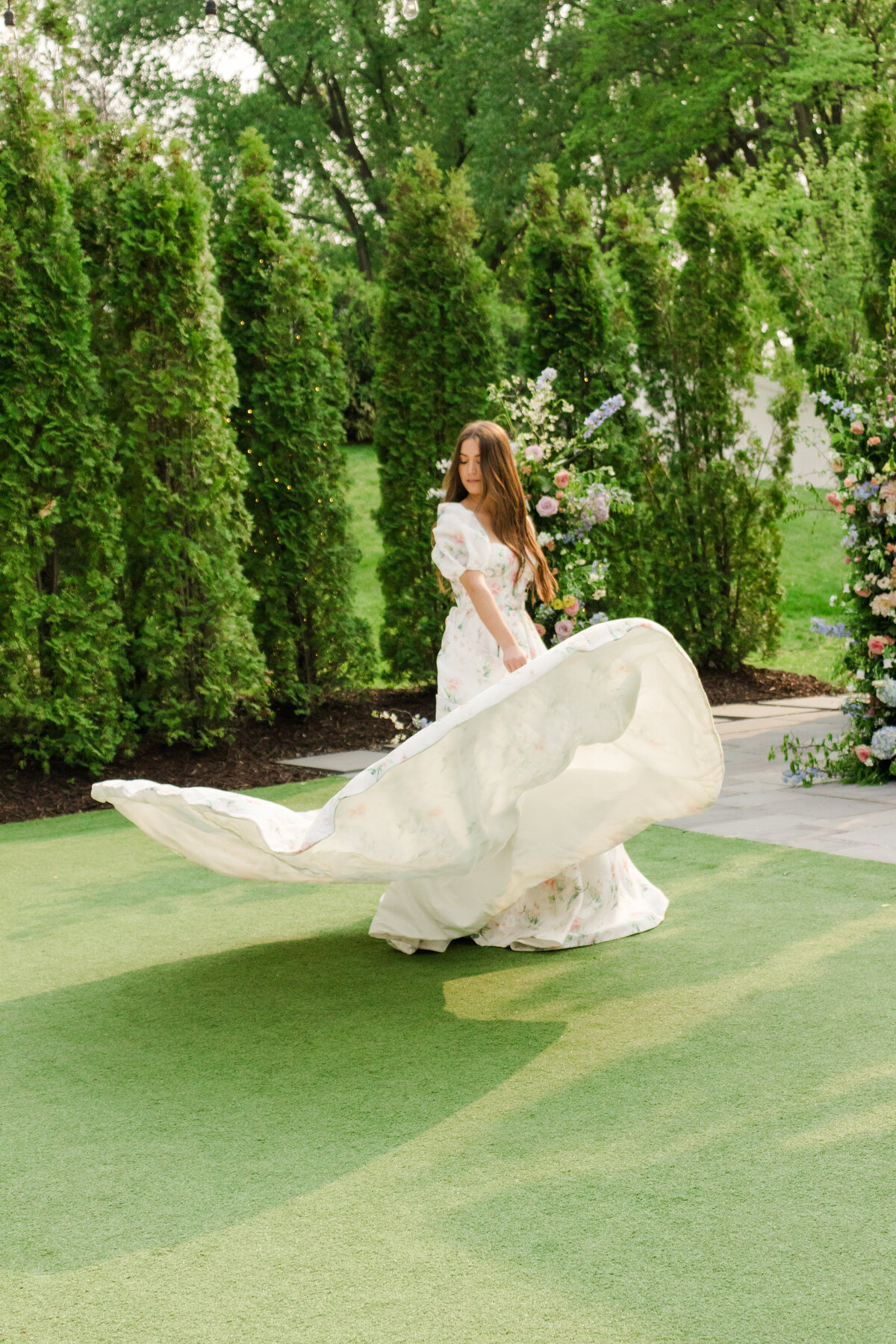 A bride spins in her flowy dress at the Hutton House with a Duluth wedding photographer to capture the movement and volume in the wedding gown.