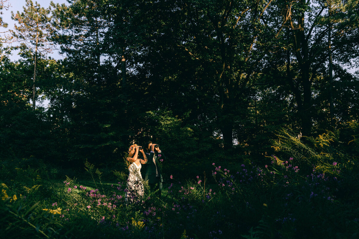 A couple birdwatch during their elopement in Central Park