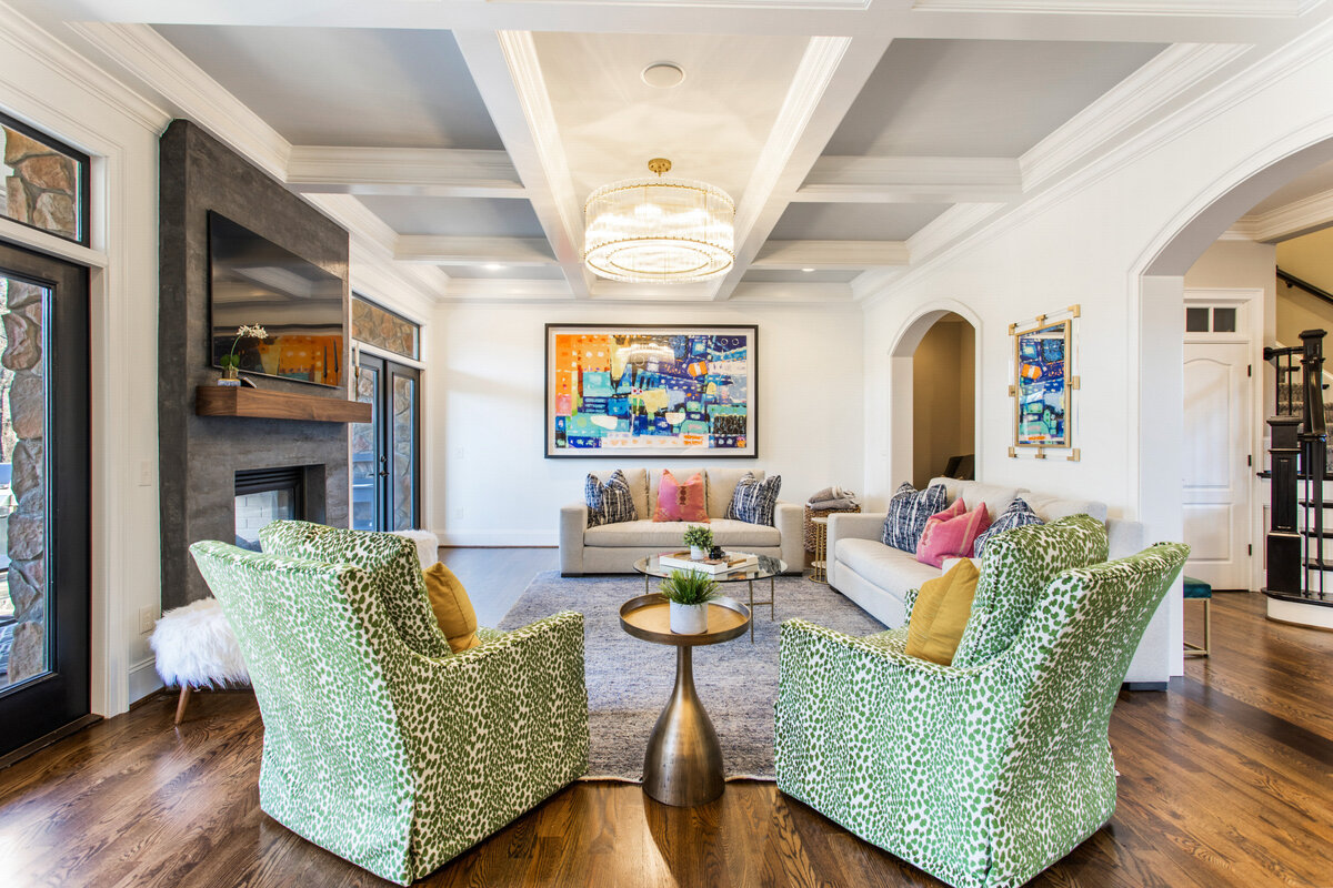 living room with white furniture and various colorful accent pieces and green chairs
