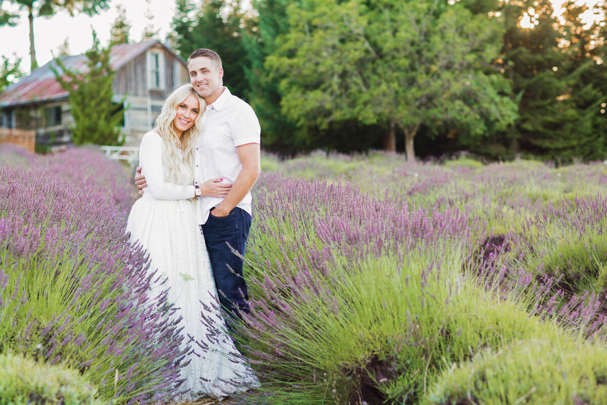 couple hugging and smiling in lavender field