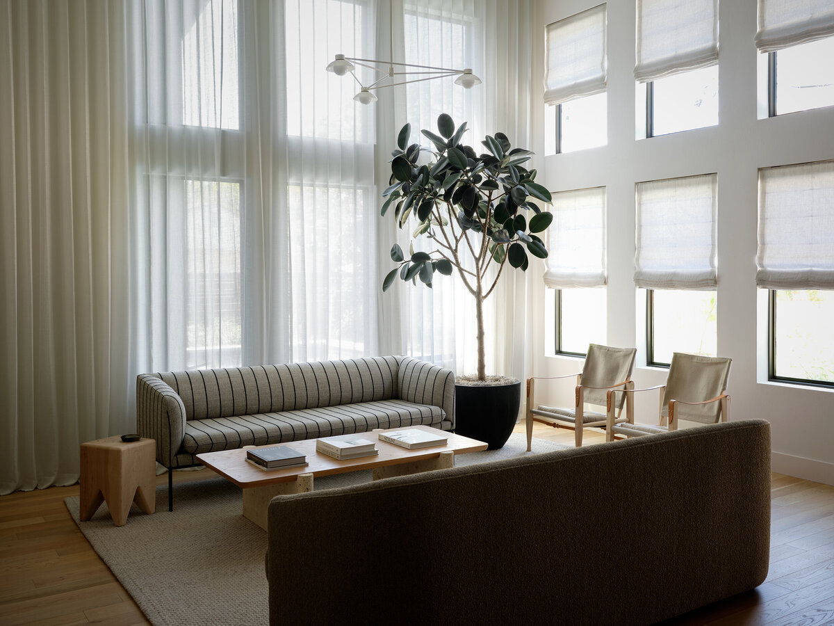 timeless-living-room-stripe-sofa-linen-curtains-allied-maker-yucca-stuff-travertine-coffee-table-oak-safari-chairs-scandinavian-interior-design-austin-home-house-franc