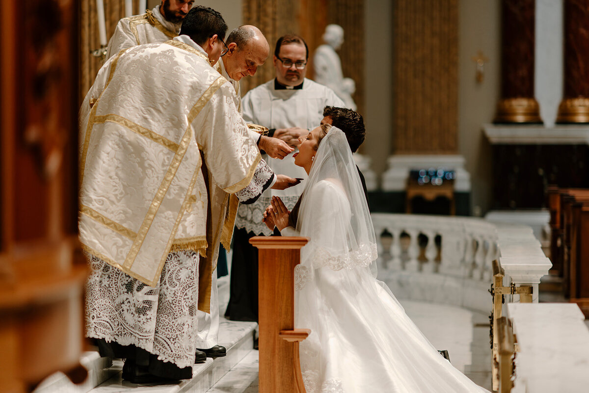 a bride receiving the Most Holy Body of Christ