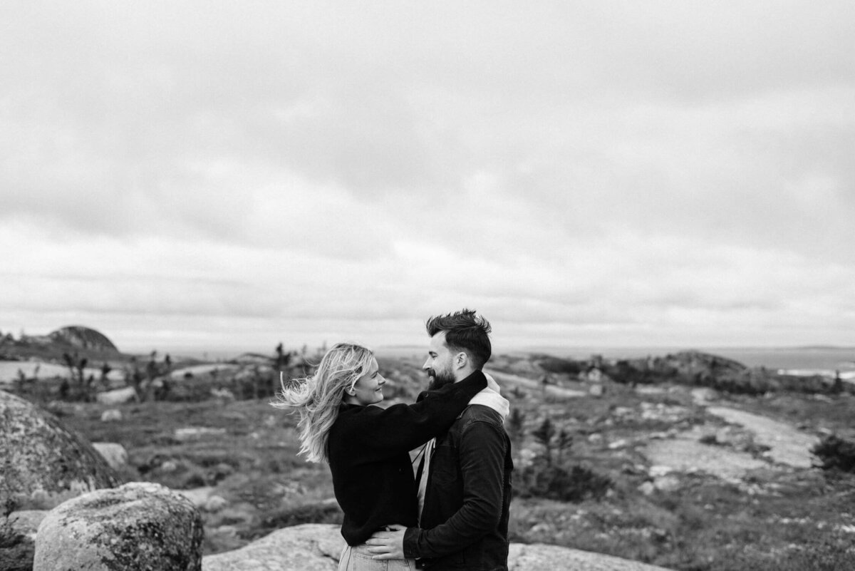 Couple gazing into each other's eyes on a windy day in Peggy's Cove.