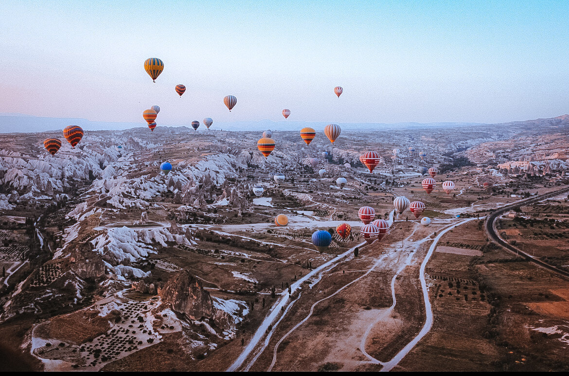 Colorful hot air balloons float in the sky