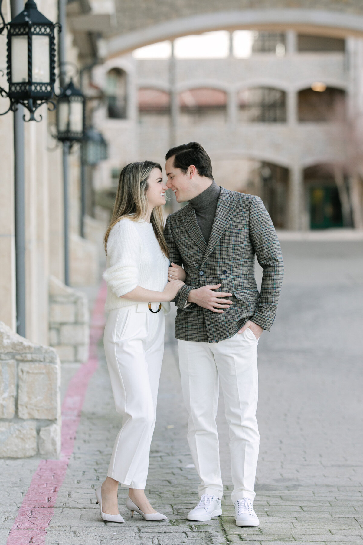 Engaged couple snuggling during their fall engagement session at Adriatica Village in Dallas