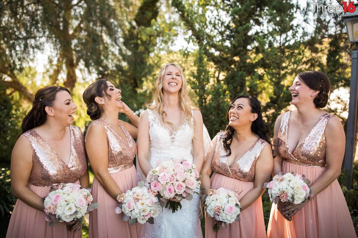 Bride and her bridesmaids share a laugh