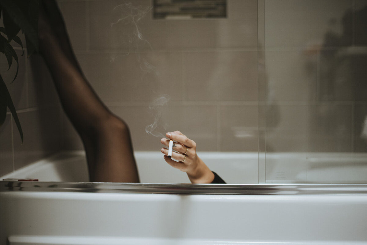 girl in a bathtub smoking