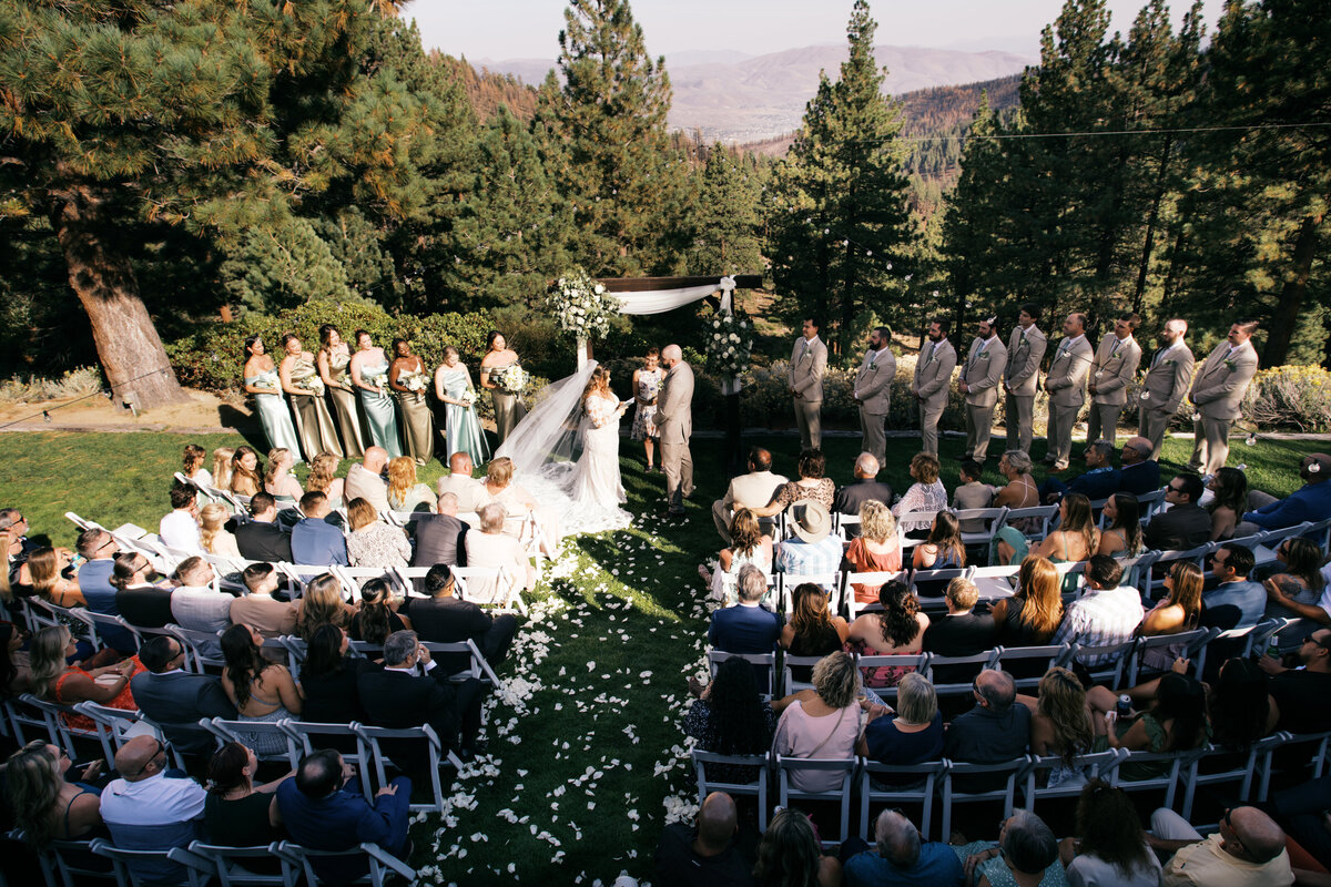 Wedding couple walking together along the ocean shoreline in an intimate coastal elopement ceremony