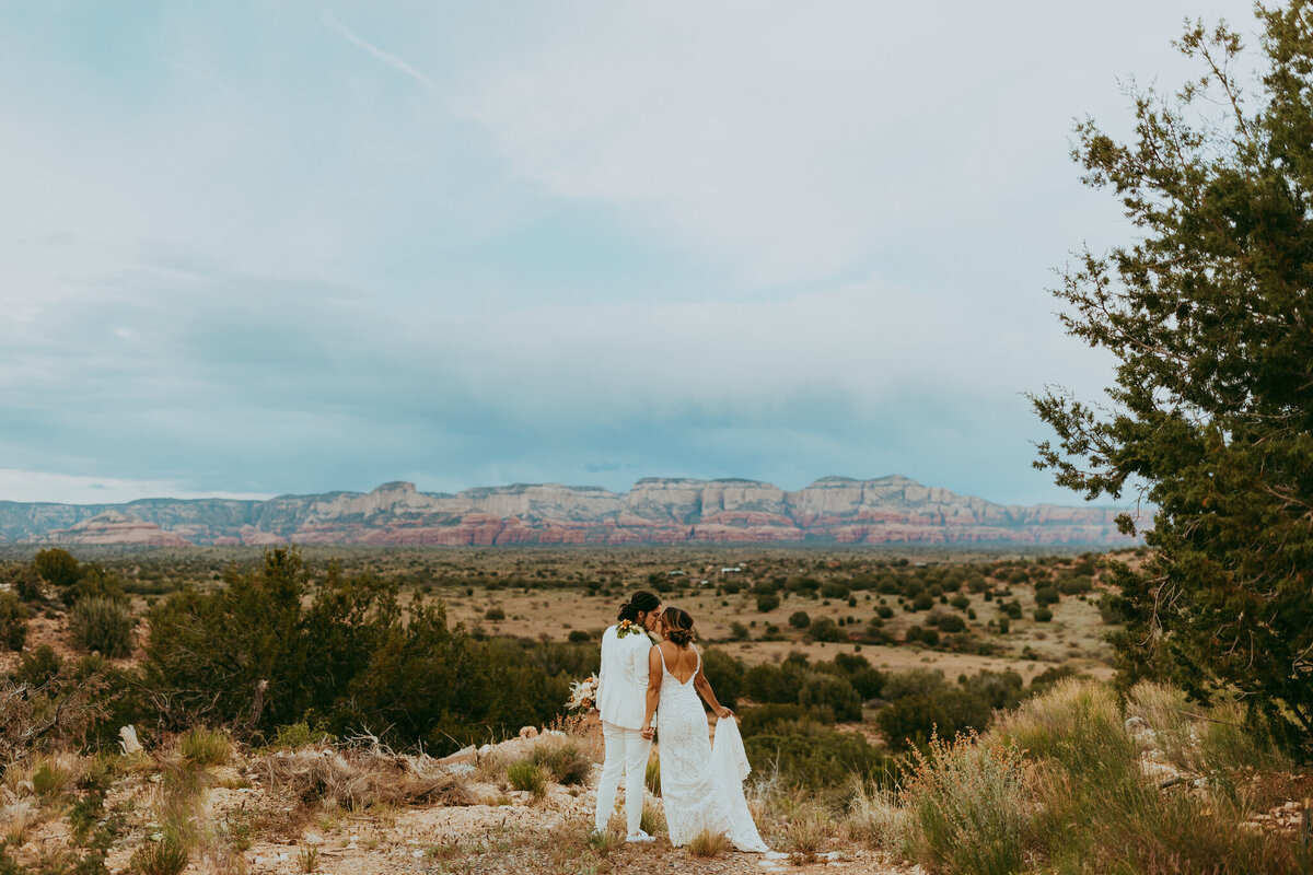 brides stand together with sedona backdrop behind them