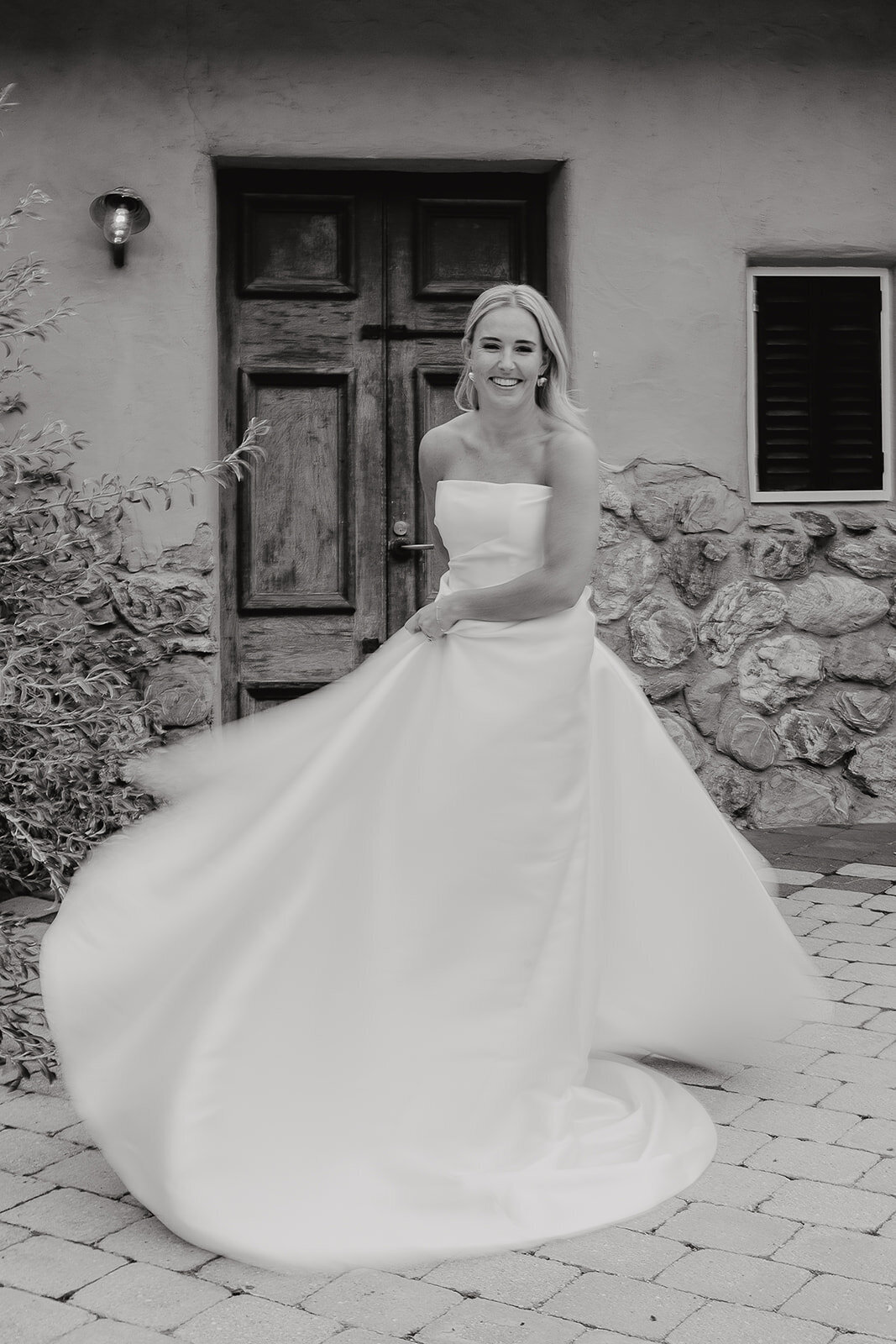 bride dancing in dress black and white image