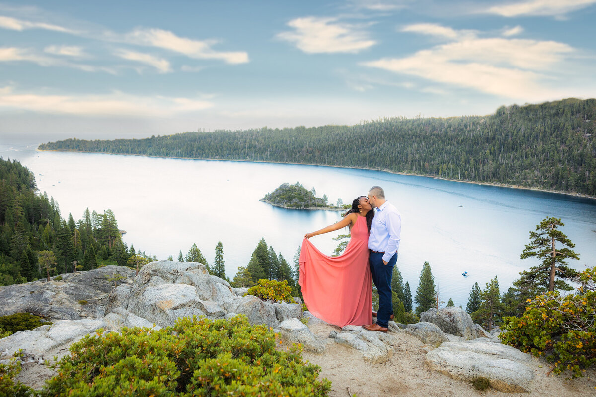 Philippe studio pro, sacramento weddingphotographer captures engaged couple above emerald bay in lake tahoe kissing.