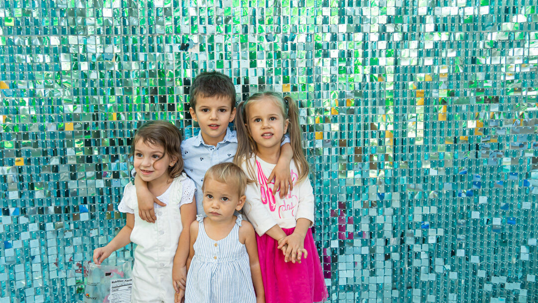 kids in front of a shimmer wall