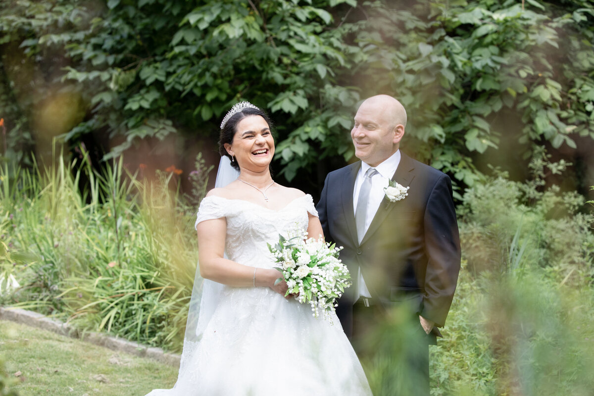 bride-laughing-groom-smiling-candid-garden-wedding-photo