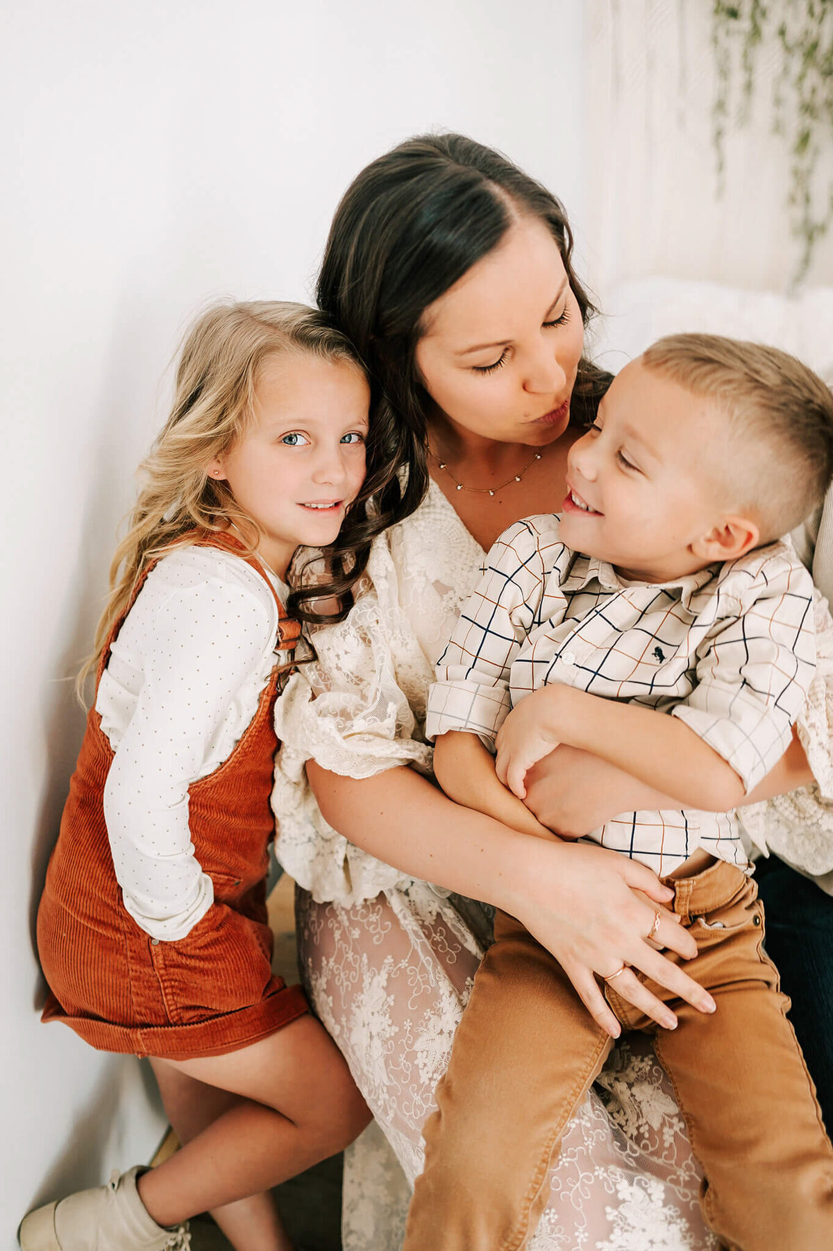 mom kissing babies during Branson MO family photography session