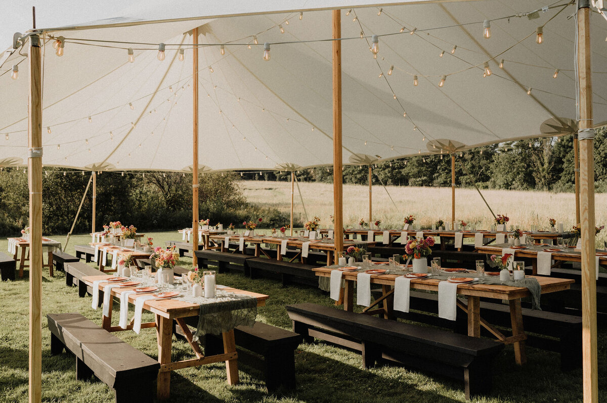 Outdoor wedding reception setup with tables in Maine