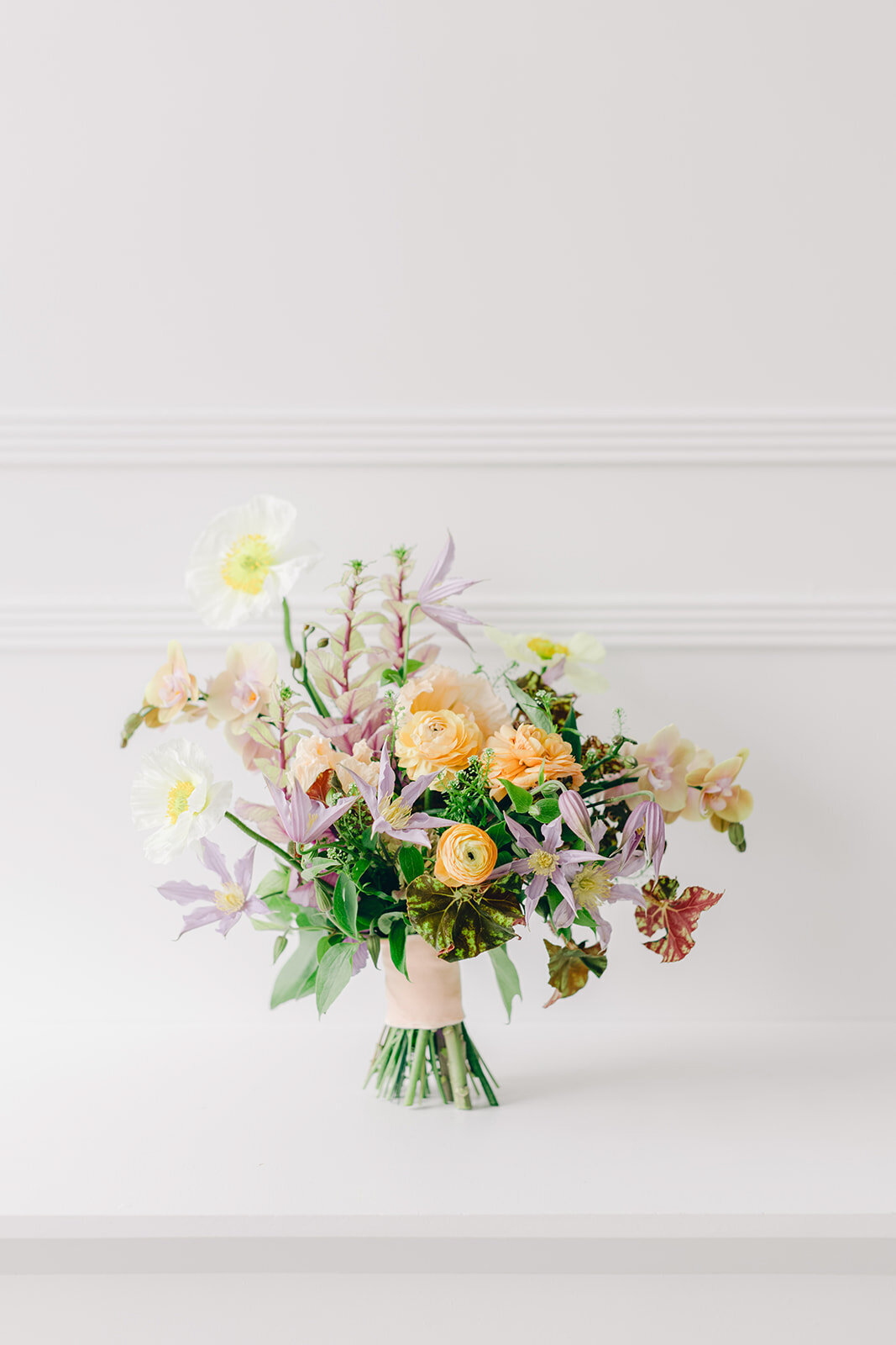 A bright, colourful garden bridal bouquet photographed for a Montreal wedding.