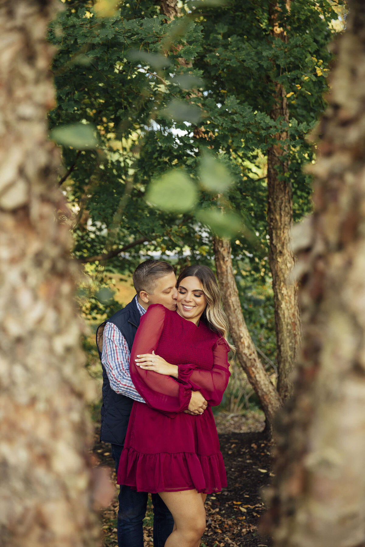 Couple kissing on cheek during photo at Sayen House and Gardens in Hamilton Township New Jersey