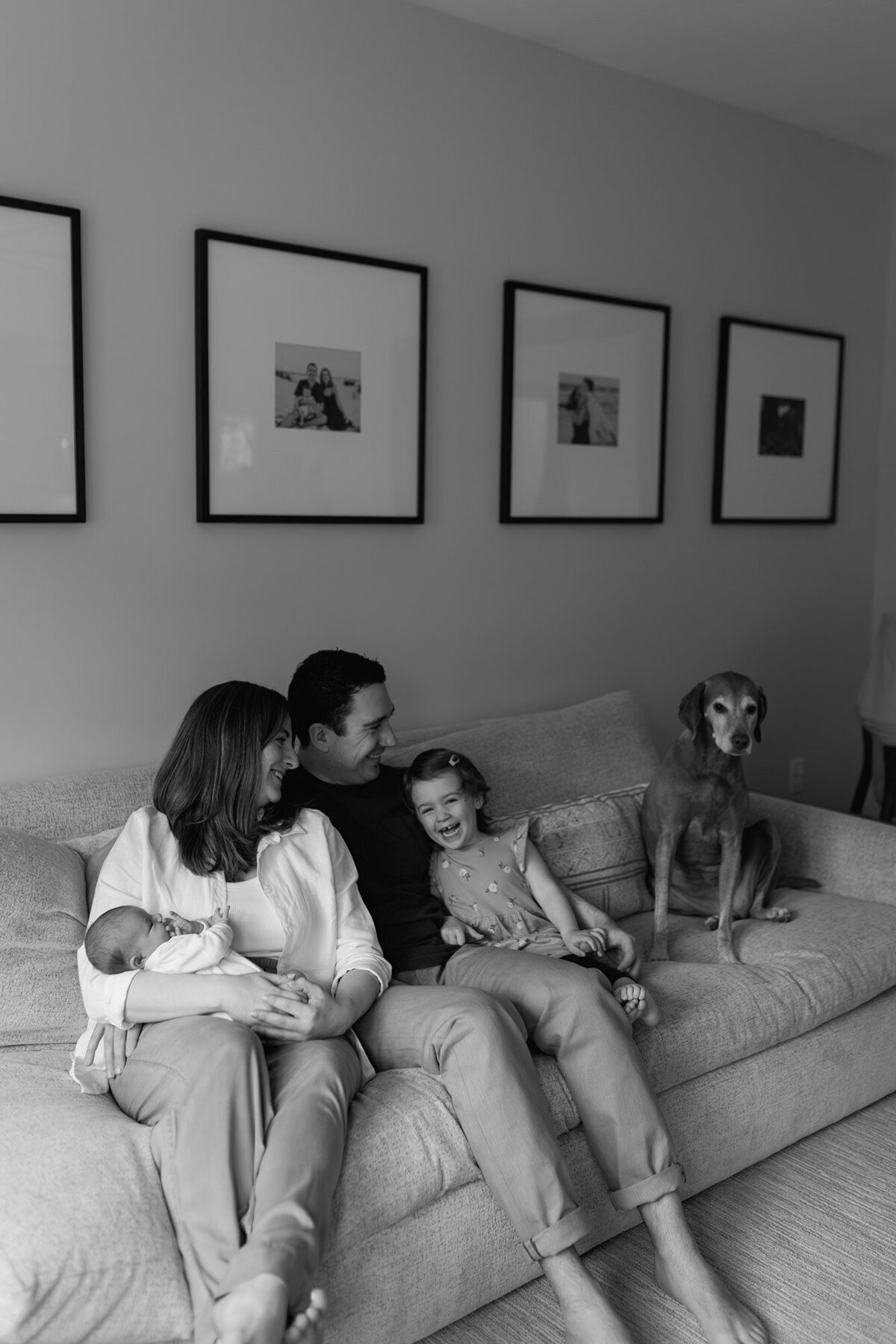 Family snuggled up together in a cozy in-home session