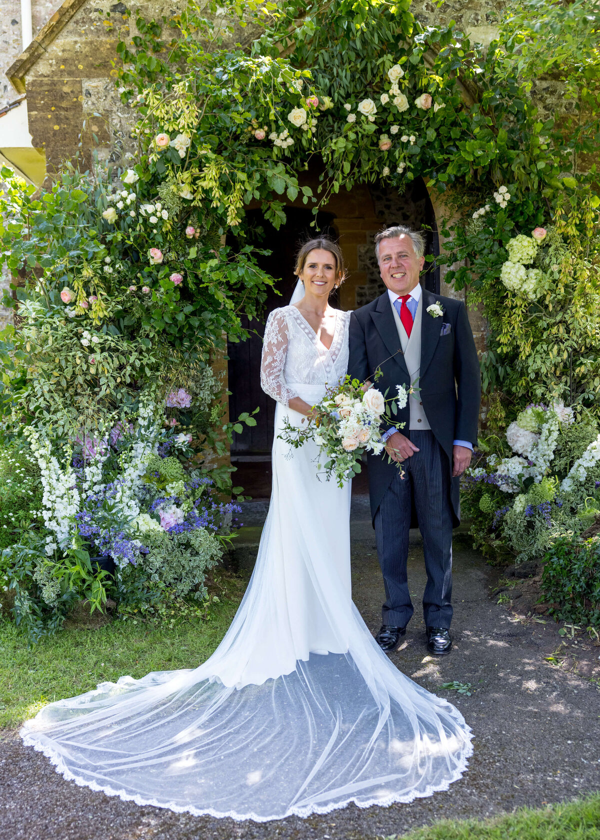 bride under church flowers