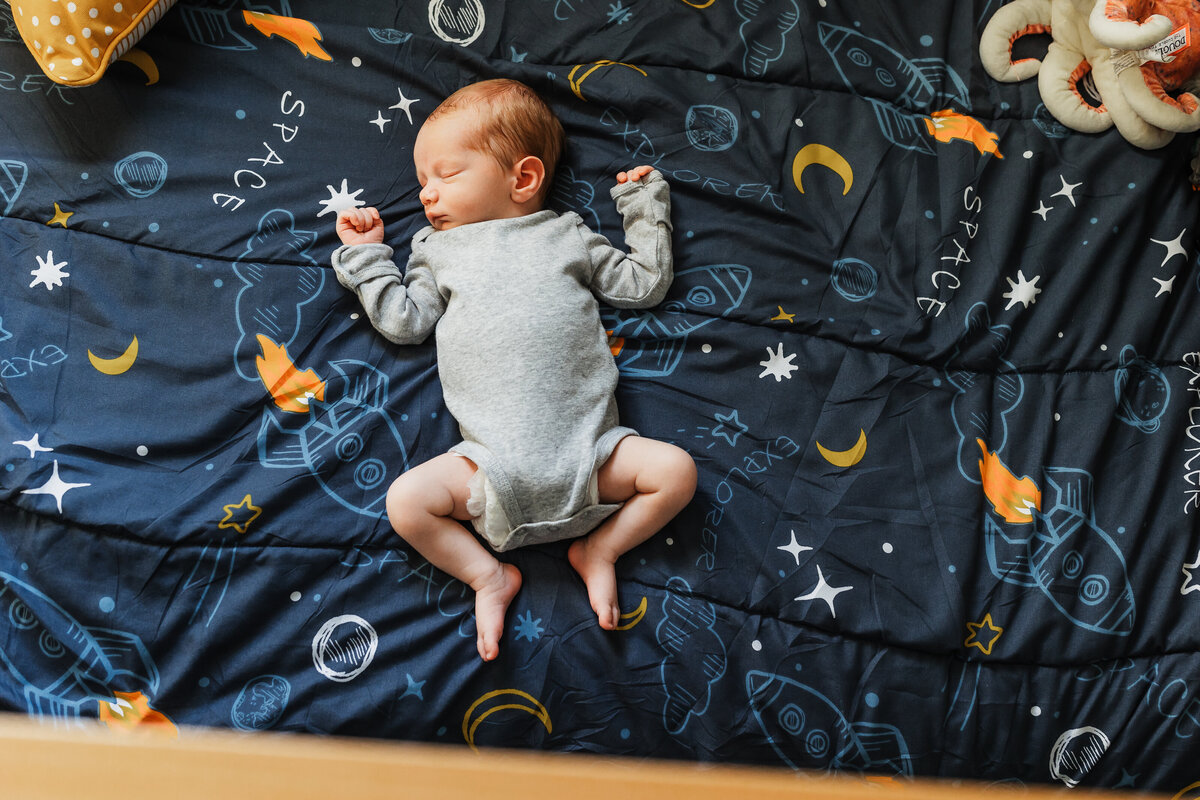 newborn baby on space themed blanket by harrisburg pa photographer