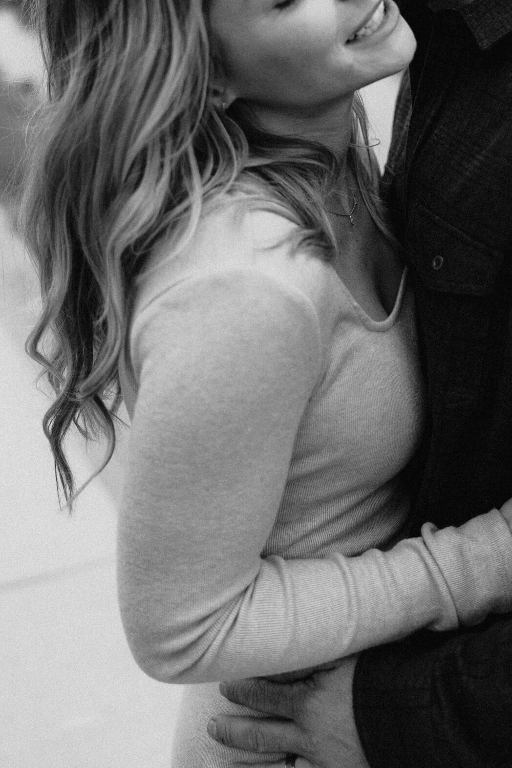 Man and woman hugging at at Finger Lakes maternity session
