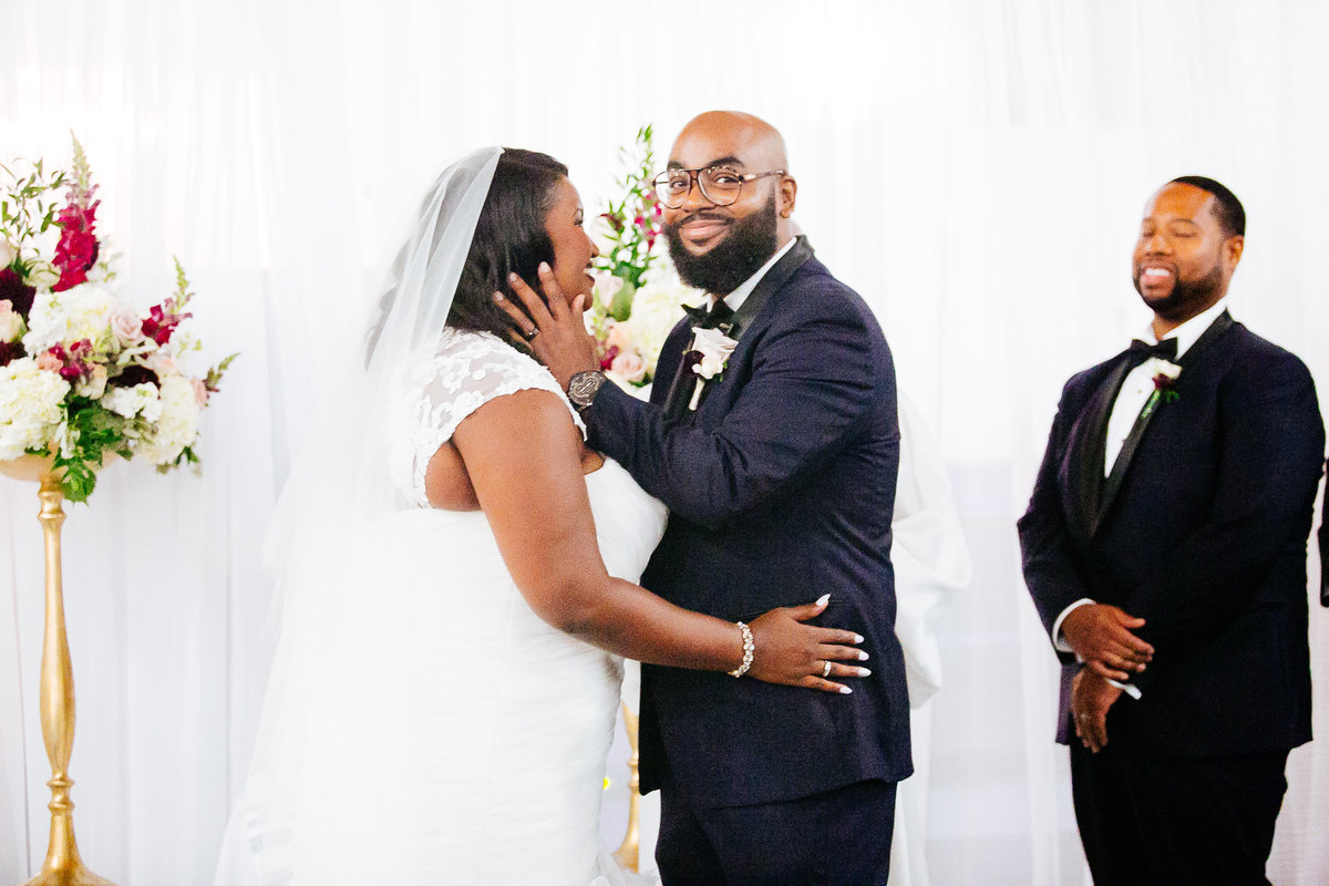 Groom looks at the camera just before he kisses his bride for the first time as husband and wife.