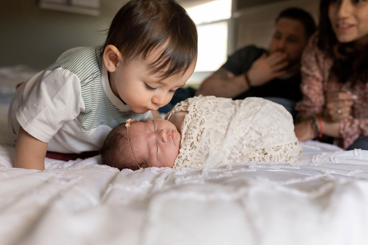 NJ Baby photographer captures big brother kissing his new sister