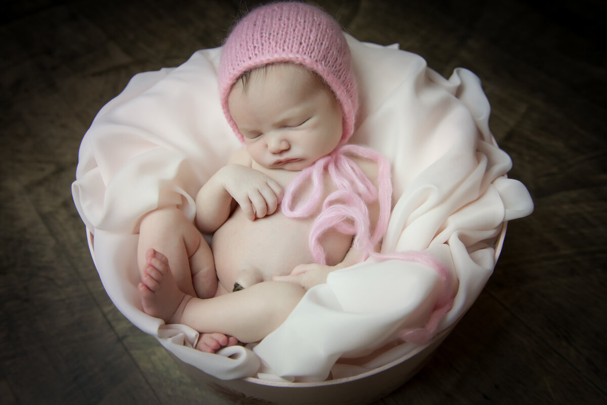 newborn baby girl asleep in vintage hat box