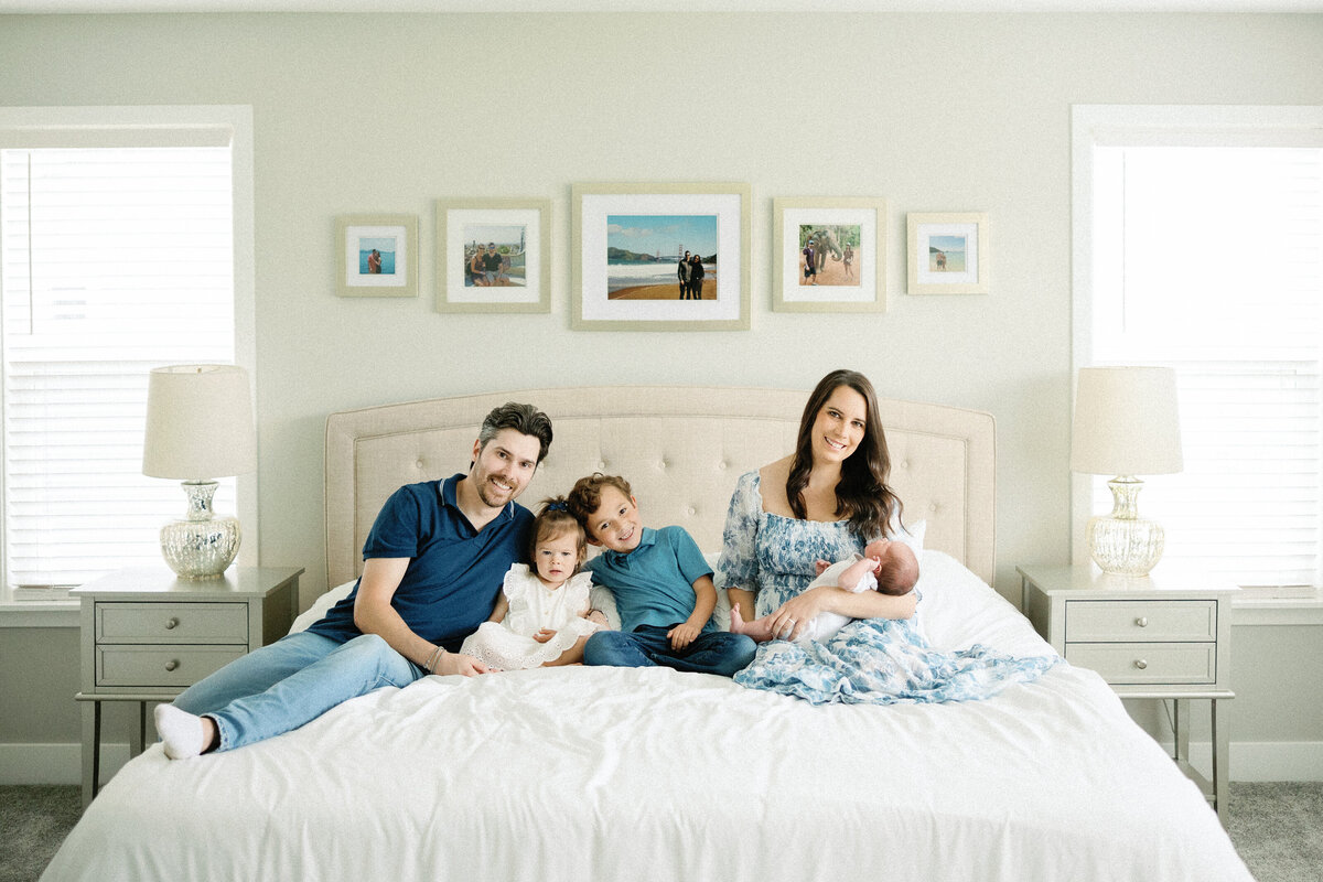 family photo with new baby in master bedroom