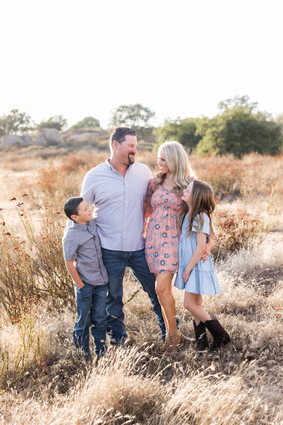 family-of-four-laughing-in-wrights-field-san-diego