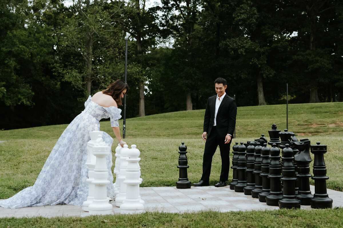 couple playing life sized chess in outdoor venue