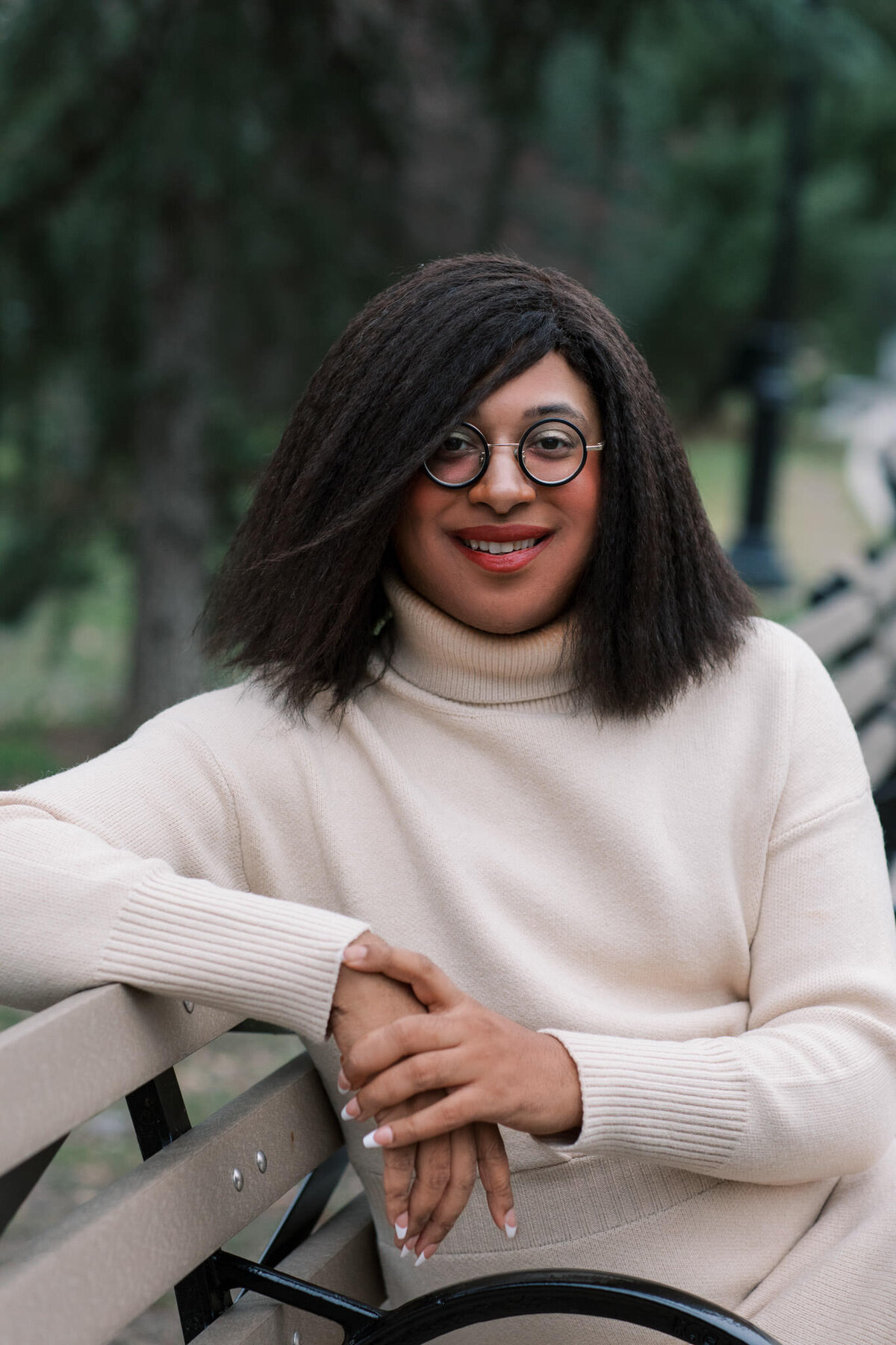 author portrait of denne michele norris sitting on a bench in nyc