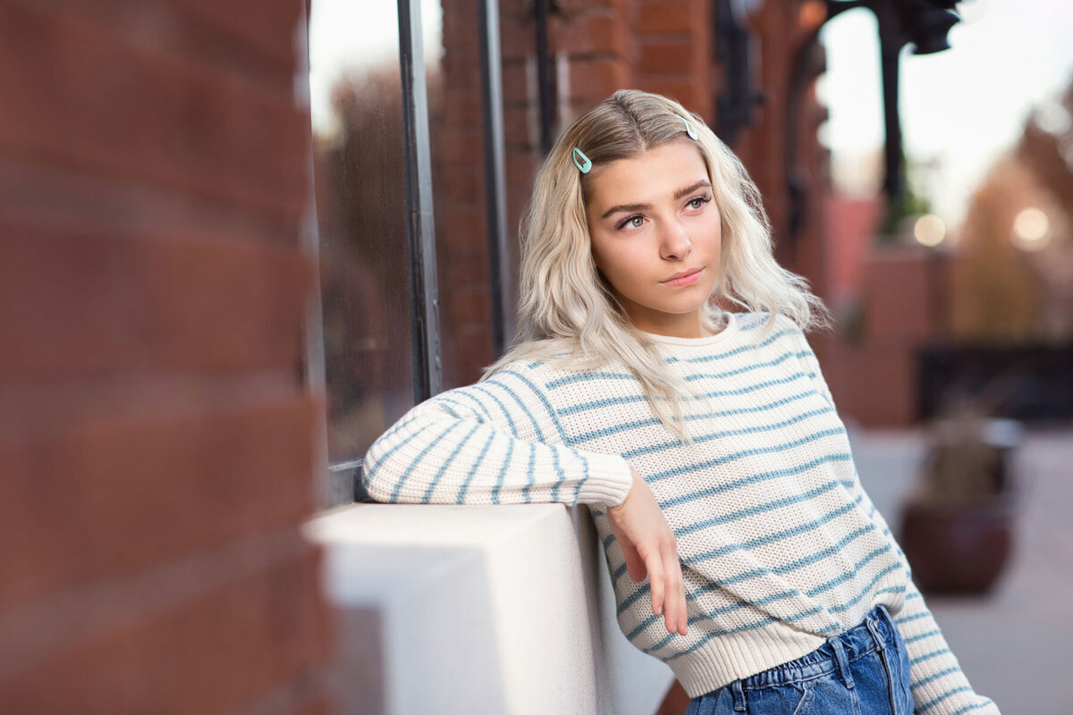 Girl looking off into the distance during senior portrait session at Trolley Square in Utah.