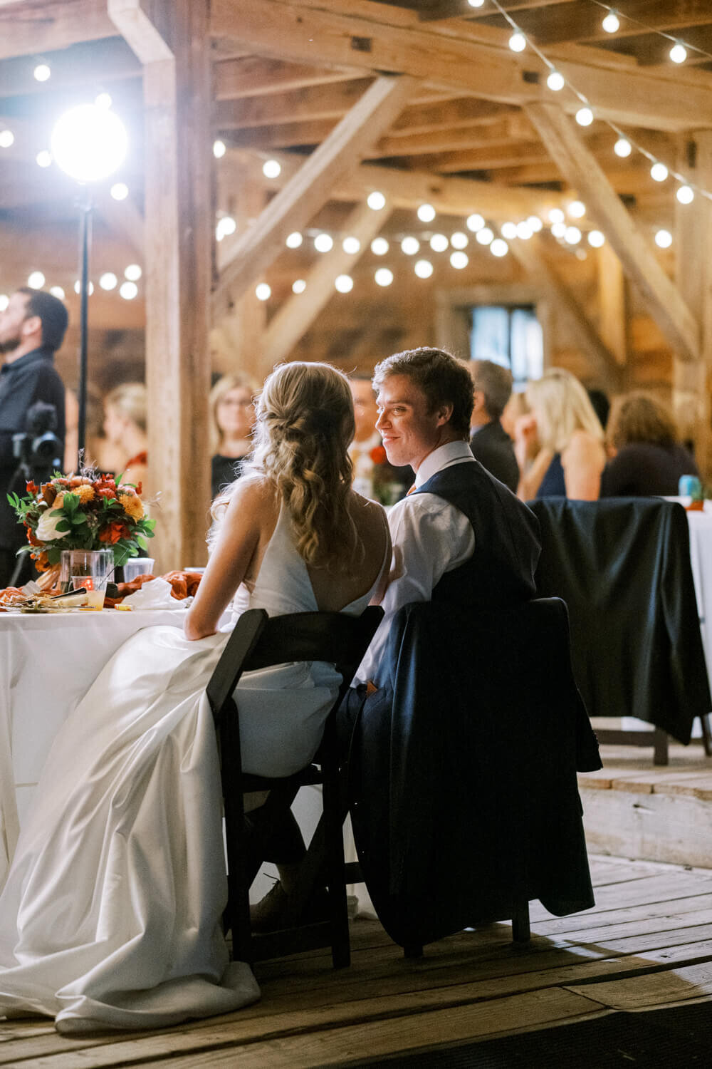 groom-looking-at-bride-at-sweetheart-table