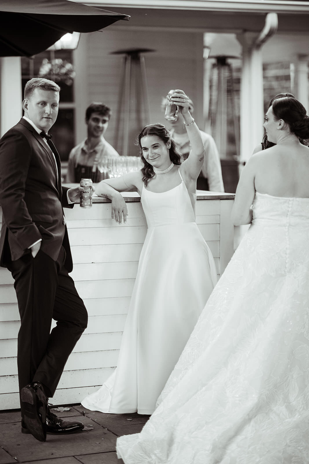 Bride holding her drink up cheersing