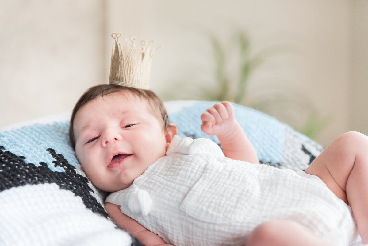 baby smiling with crown on his head