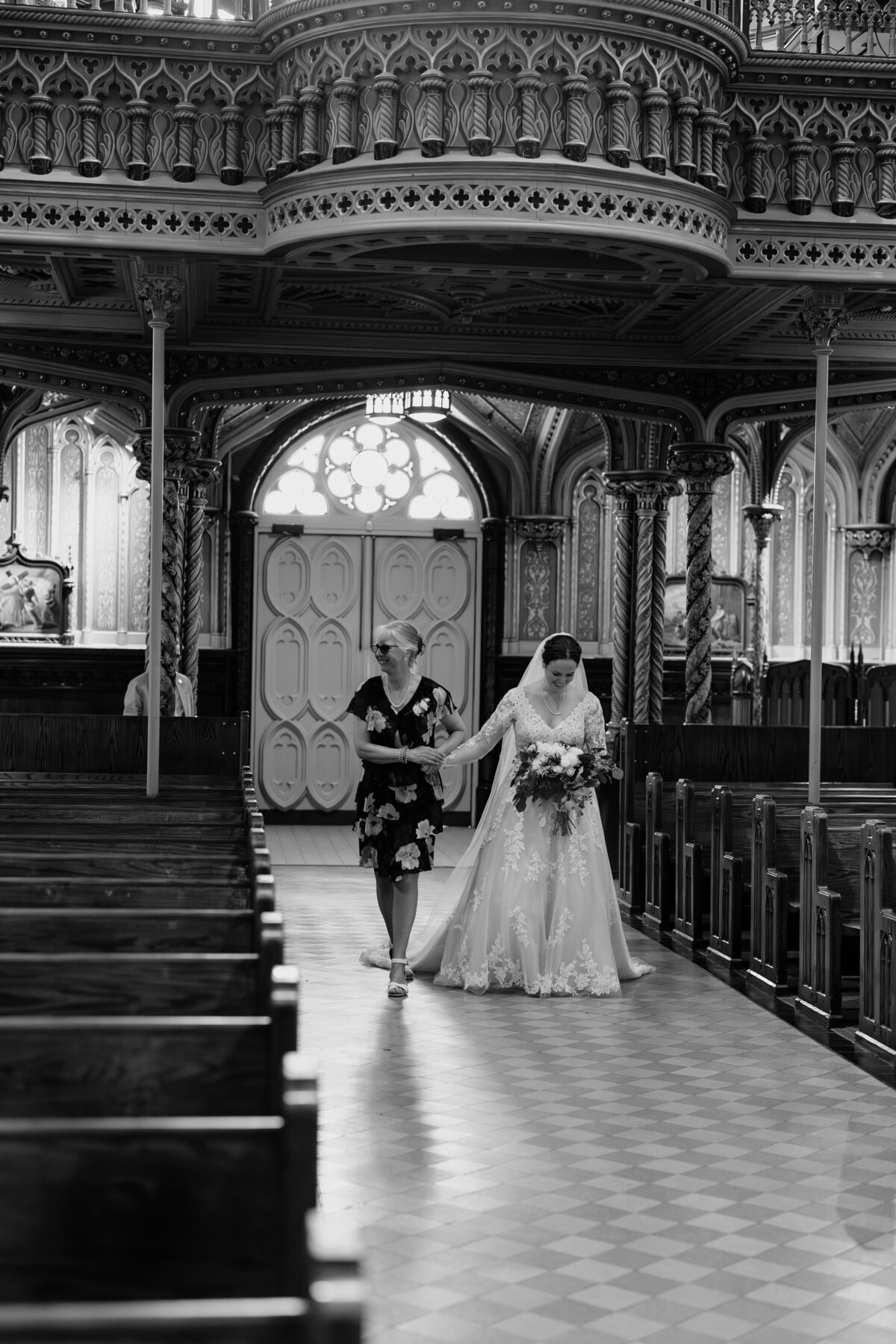 A bride walking down the aisle with her mother