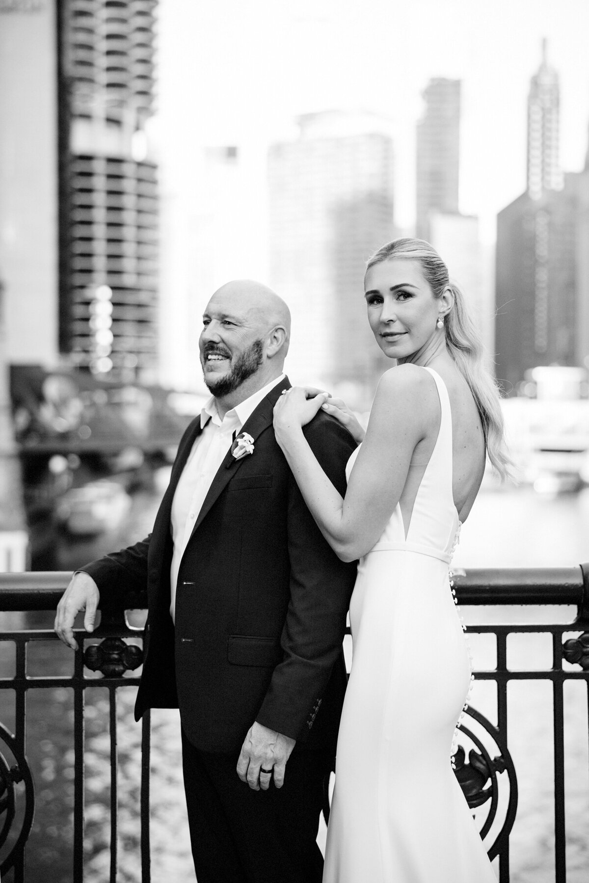 Black and white portrait of groom and bride on the Chicago river bridge