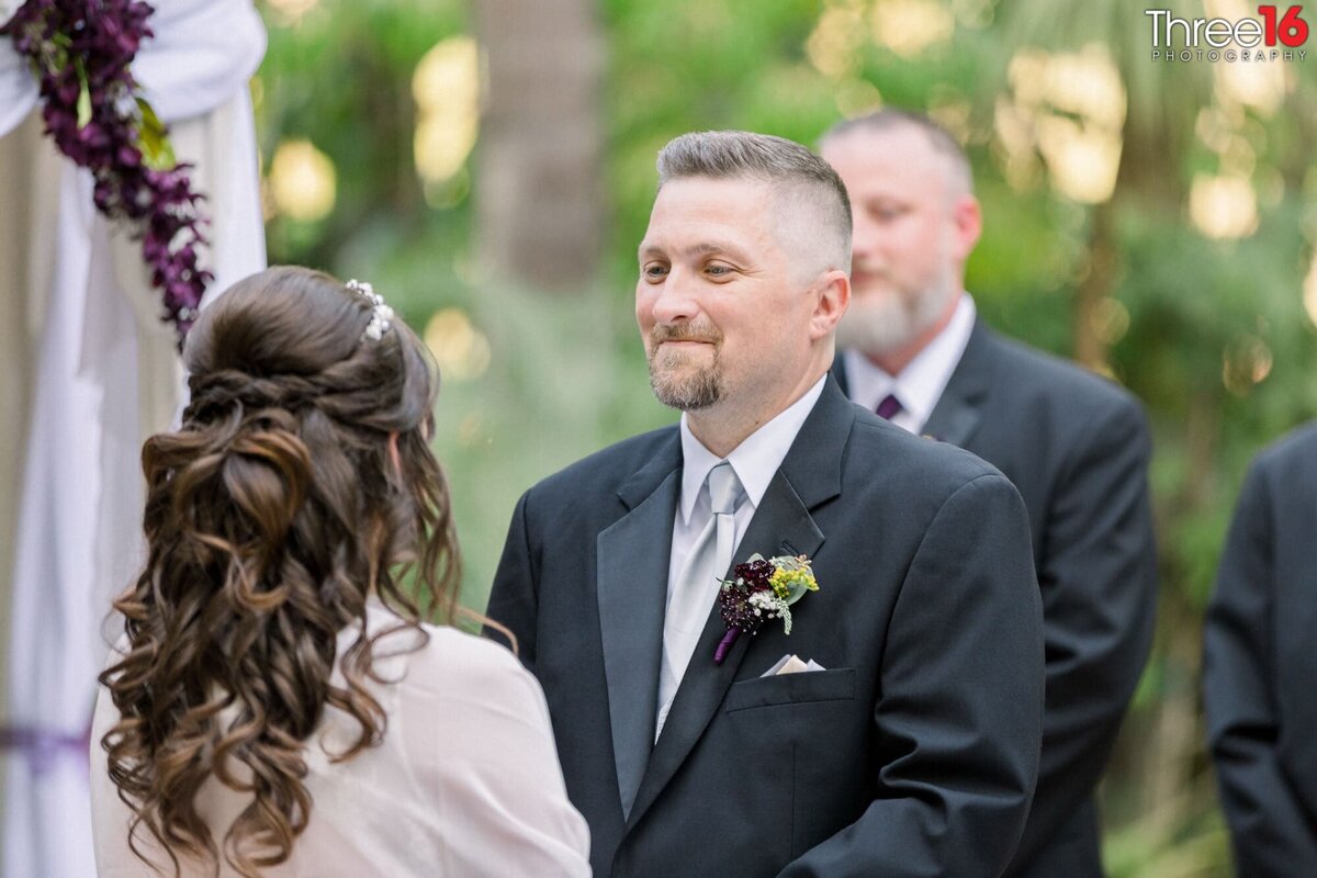 Groom looks at his Bride during their wedding ceremony