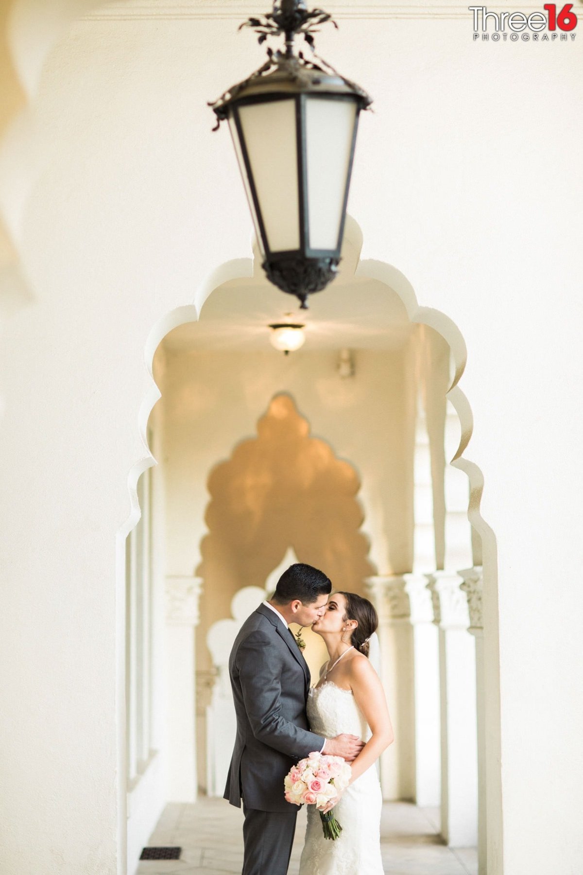 Bride and Groom share an intimate kiss in the corridor at the Brand Library Park