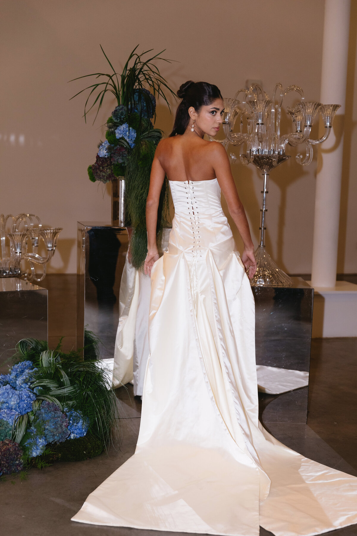Editorial bridal fashion moment showcasing a sleek satin wedding dress and modern styling.