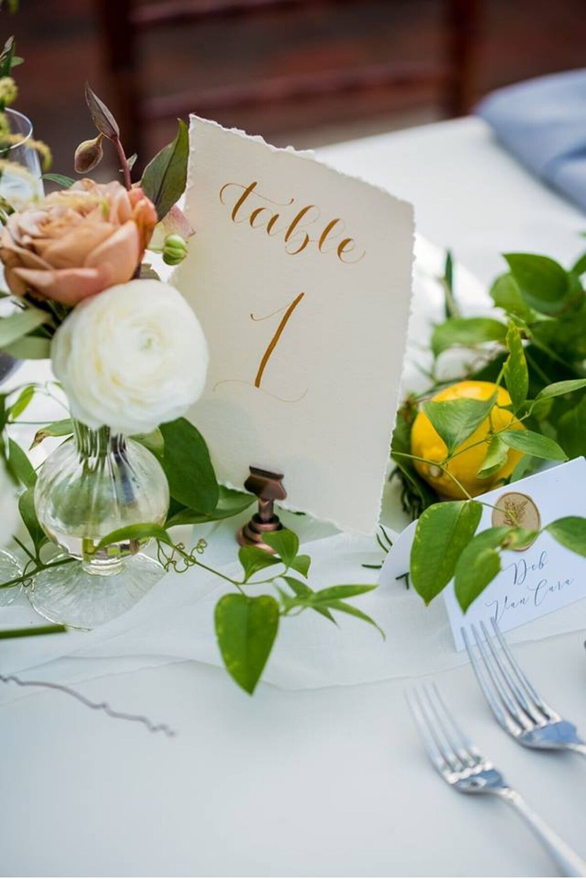 Greenery and lemon table design with an elegant calligraphy table number at a luxury Italian inspired Chicago North Shore wedding.
