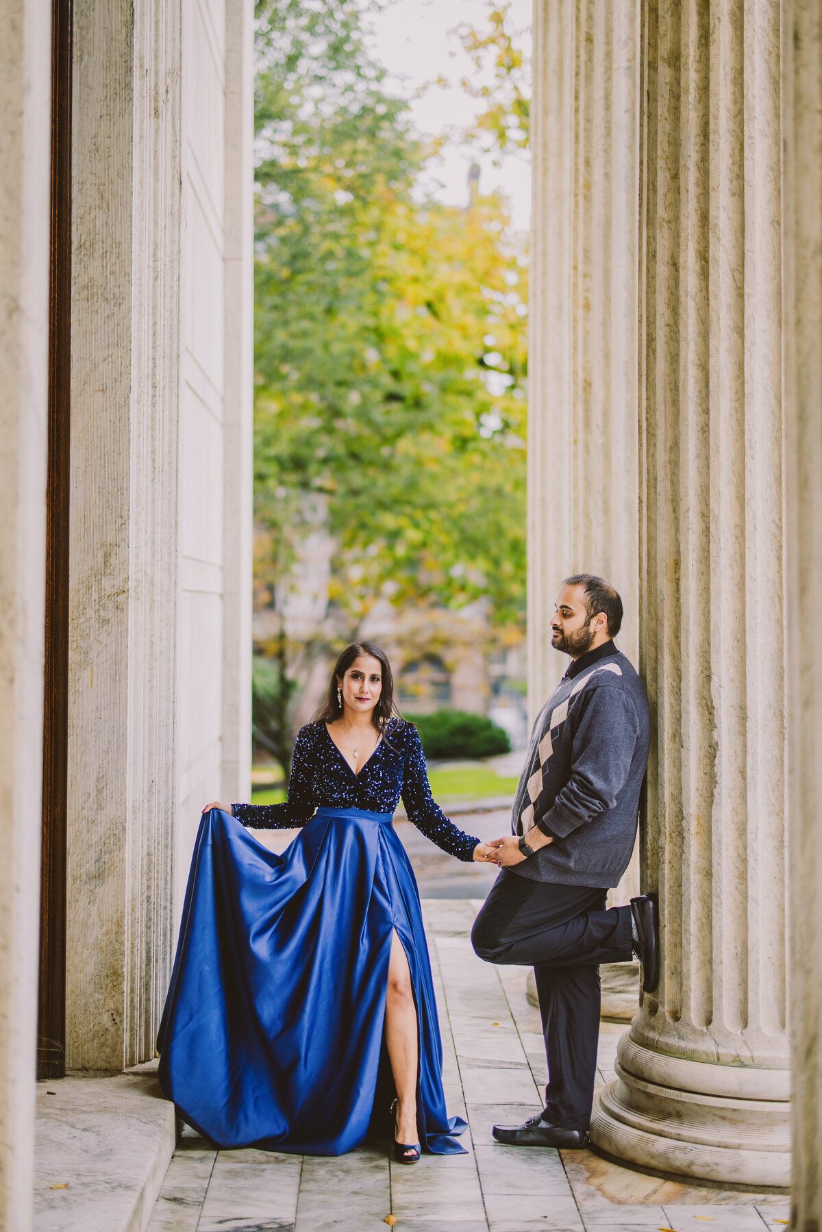 A couple standing near the columns at princeton university outside the clio and whig halls