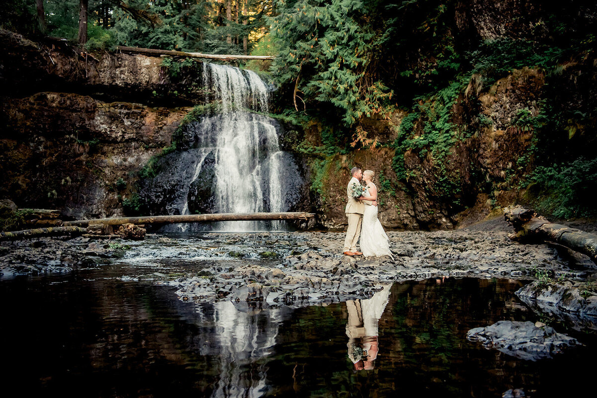 bride and groom at waterfall