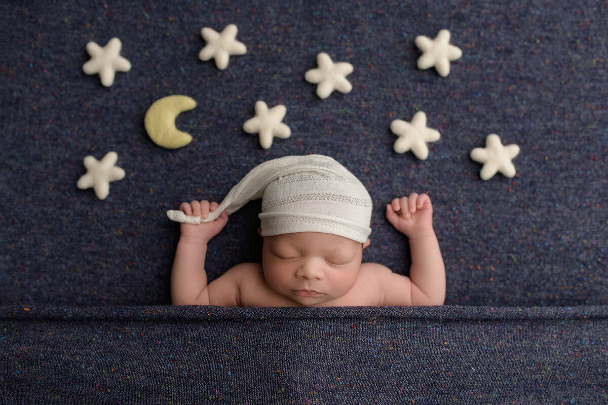 sleeping newborn with moon and stars