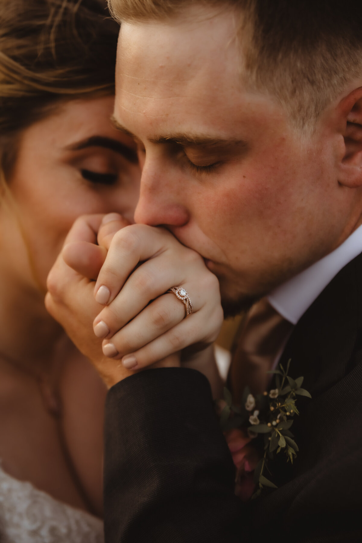 GROOM KISSING BRIDES HAND