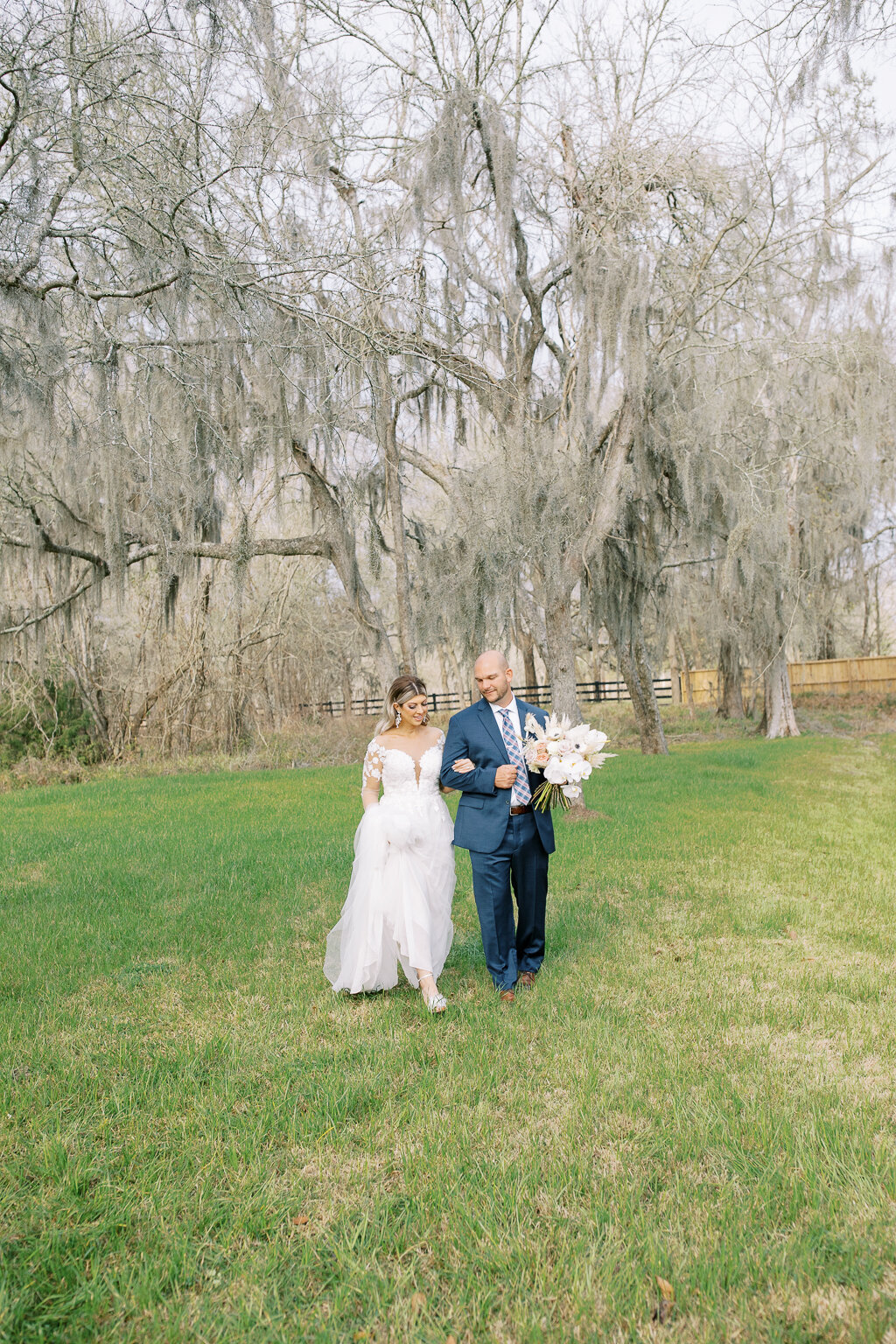 Elopement Photography, couple walking in a field under tall trees