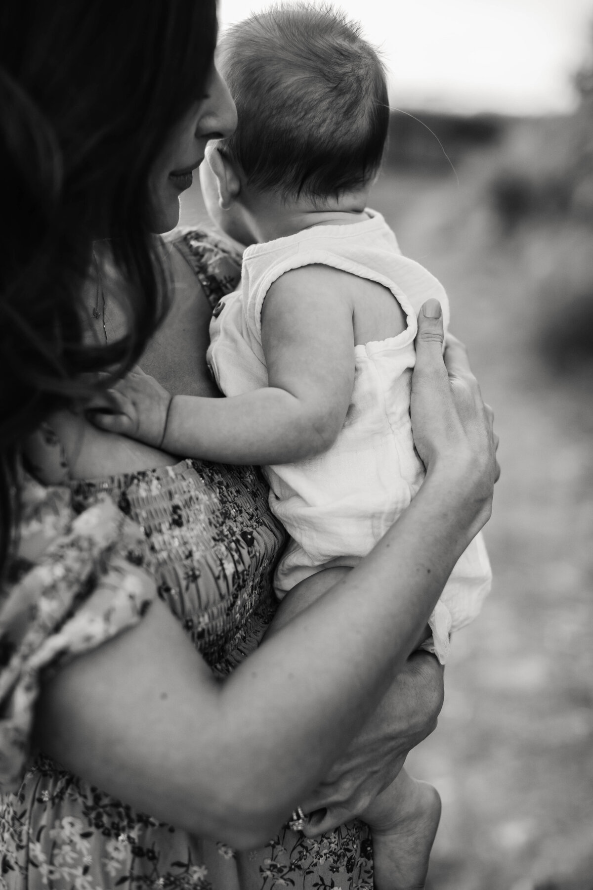 Black and white image of mom holding baby boy.