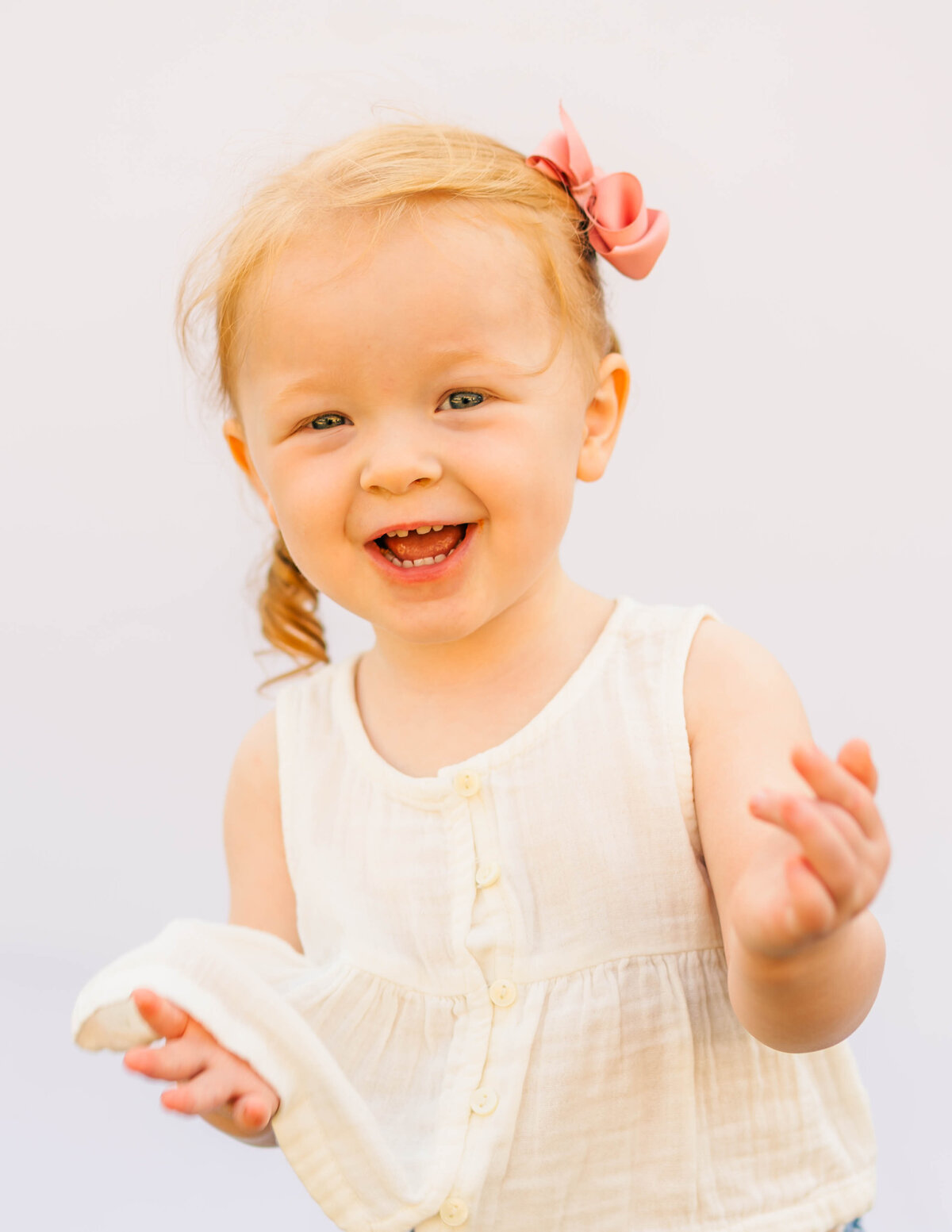 Fine art toddler portrait with soft lighting and neutral white background