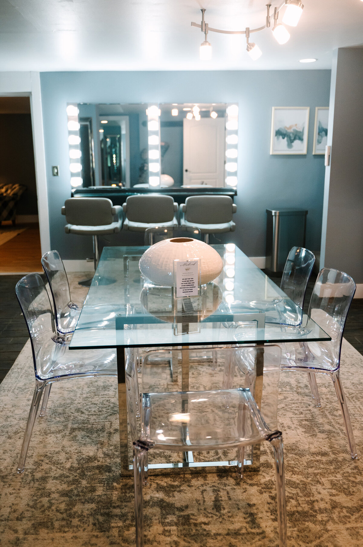 the glass dining table with CB2 dining chairs in the preparation cottage dressing room suites at Willowbrook wedding venue